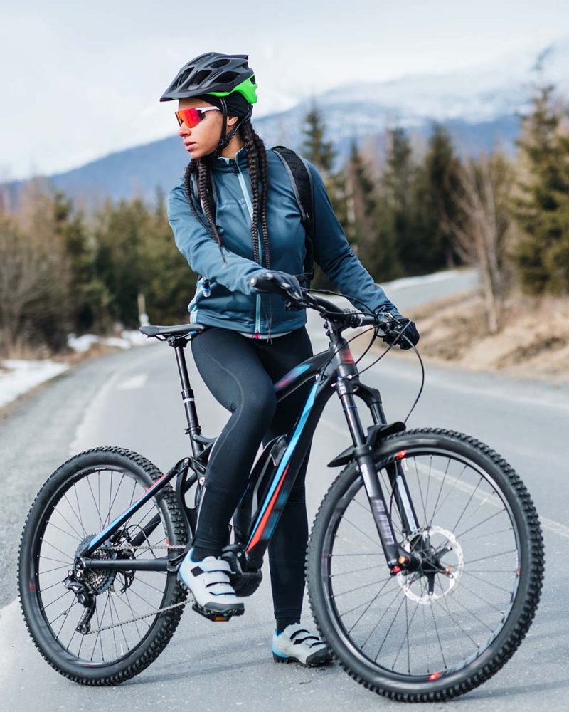 female-mountain-biker-standing-on-road-outdoors-in-FJDFVR6.jpg